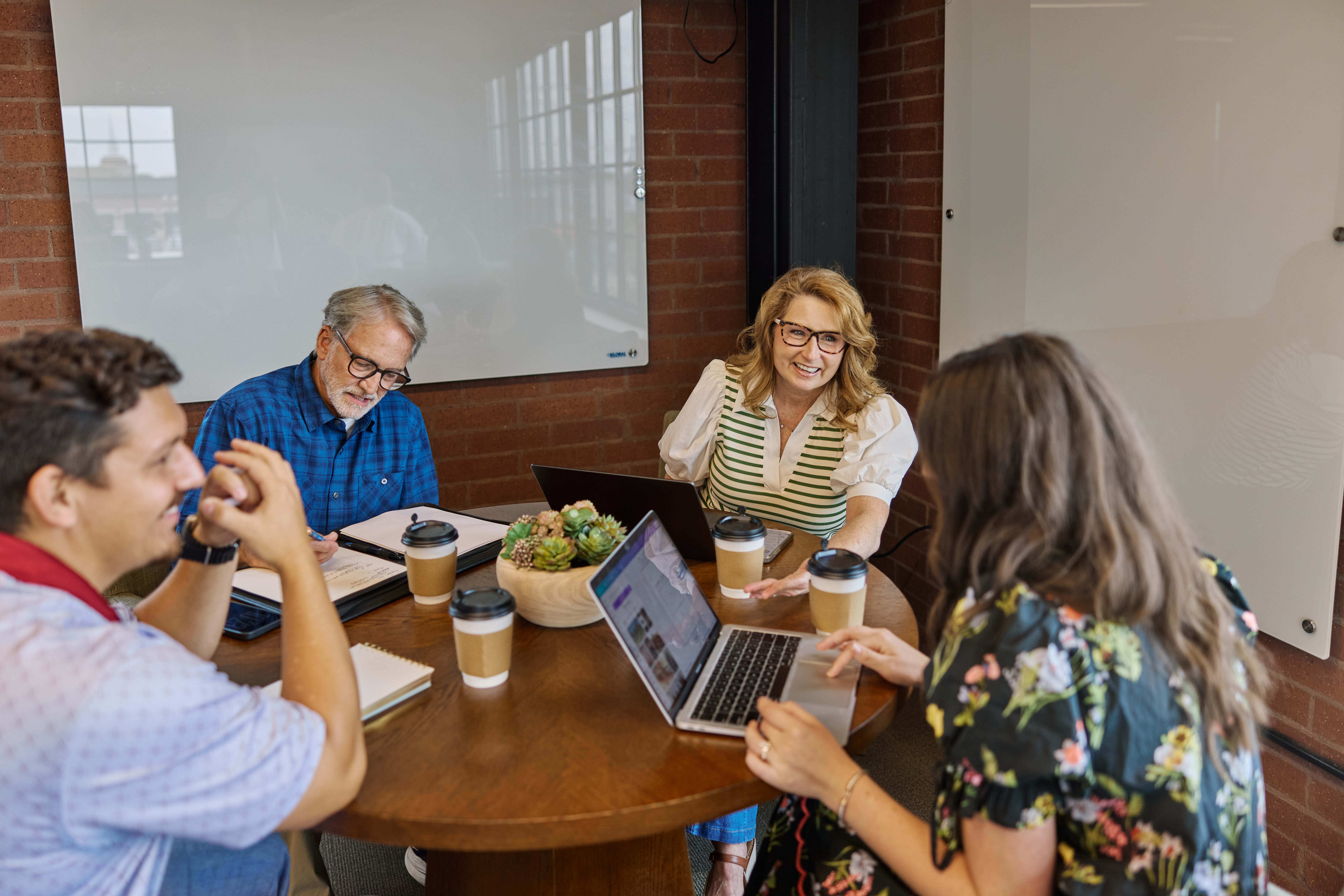 Members collaborating around a table at The Station Work Club